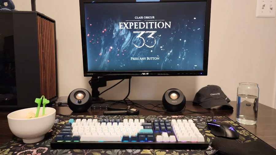 Danielle’s desk with Clair Obscur: Expedition 33 on the monitor, a backlit mechanical keyboard and a gaming mouse